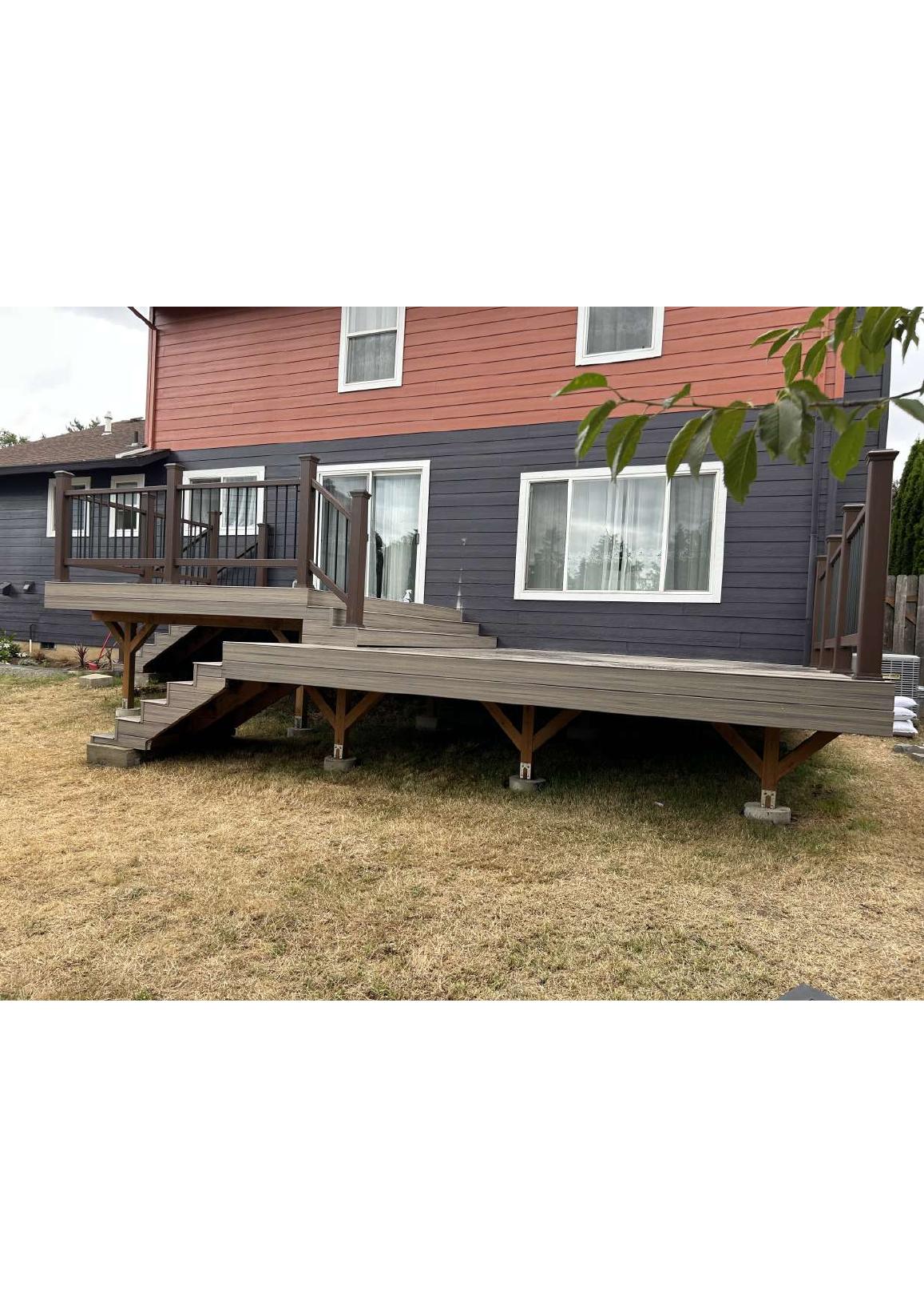 Large multi-level composite deck built behind a two-story home